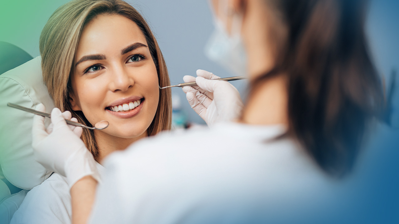 Woman in dental chair getting her teeth cleaned