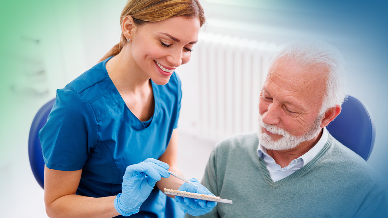 Man in dental chair looking at dental implants